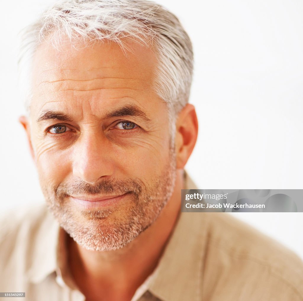 Close-up of a mature man smirking