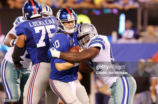 DeMarcus Ware of the Dallas Cowboys sacks Eli Manning of the New York Giants in the first half at MetLife Stadium on September 5, 2012 in East...