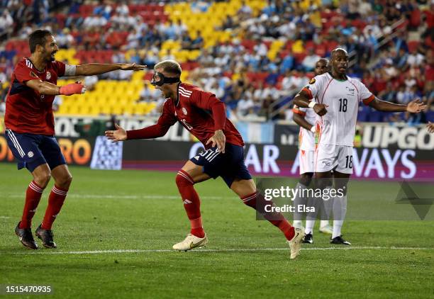 Francisco Calvo of Costa Rica celebrates his goal with teammate Celso Borges as Jonathan Rivierez of Martinique reacts during the first half of the...