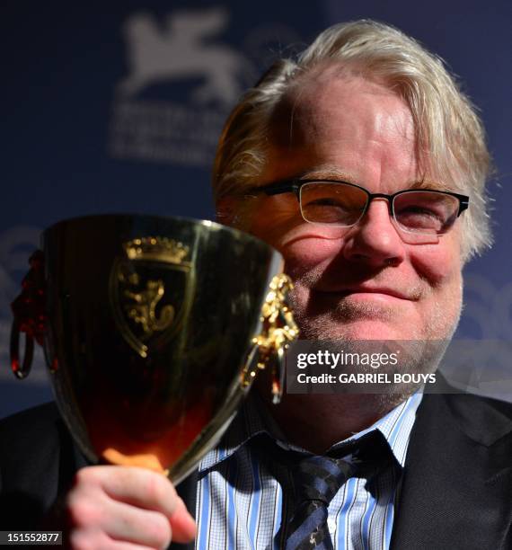 Actor Philip Seymour Hoffman poses with the Coppa Volpi for the Best Actor he received with US actor Joaquin Phoenix for "The Master" during a...