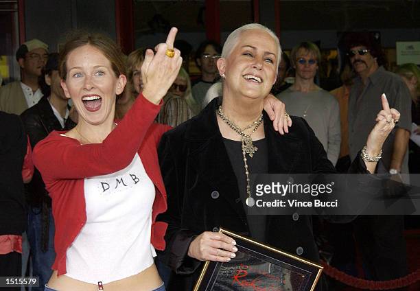 Musician Grace Slick and daughter actress China Kantner give the finger to the media at a handprint ceremony inducting Slick into the Hollywood Rock...