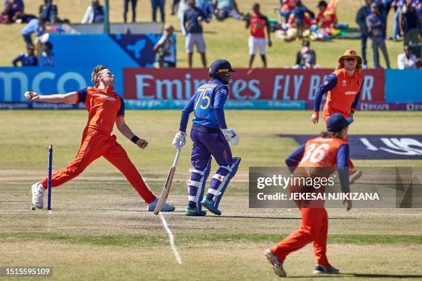 Netherlands' Logan Van Beek delivers a ball as Sri Lank's Dhananjaya de Silva looks on during the ICC Men's Cricket World Cup Qualifier Zimbabwe 2023...