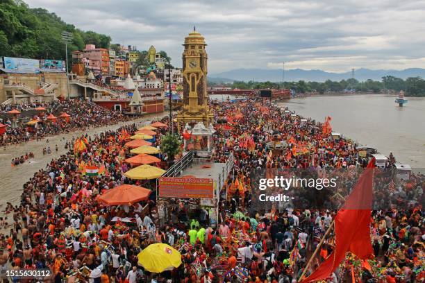 Kanwariyas, the devotees of Hindu god Shiva, gather to collect holy water from river Ganges for 'Kanwar Yatra' pilgrimage during the holy month of...