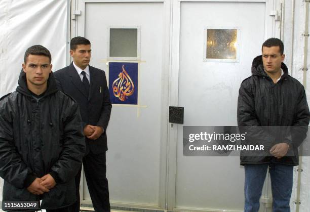 Lebanese security men stand guard at the entrance of Qatari-based Al-Jazeera television channel's makeshift office in Beirut 26 March 2002. Around...