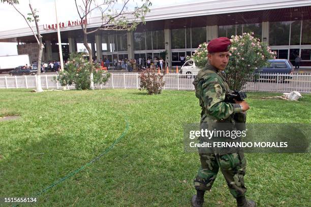 Salvadoran army soldier guards, 22 March 2002, outside the El Salvador International Airport in Comalapa, El Salvador. Some four thousand soldiers...