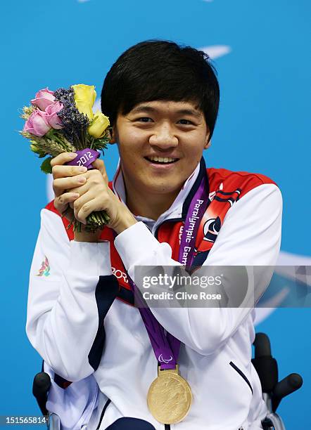 Gold medallist Byeong-Eon Min of Korea poses on the podium during the medal ceremony for the Men's 50m Backstroke - S3 final on day 10 of the London...