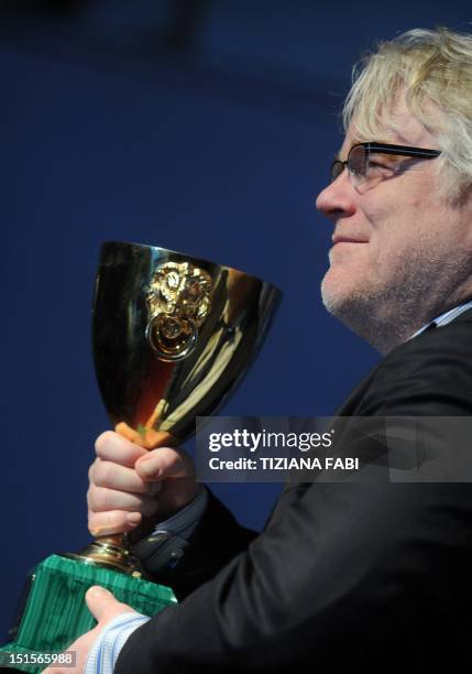 Actor Philip Seymour Hoffman poses with the Coppa Volpi for the Best Actor he received with US actor Joaquin Phoenix for "The Master" during a...