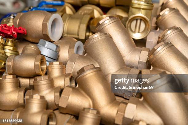 metallic brass faucet and valve: essential plumbing component for construction projects - pezzo di ricambio foto e immagini stock