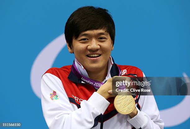 Gold medallist Byeong-Eon Min of Korea poses on the podium during the medal ceremony for the Men's 50m Backstroke - S3 final on day 10 of the London...