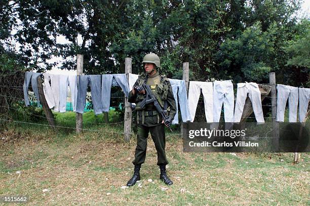 Colombian special forces soldier stands guard during raids in the Pablo Neruda neighborhood after a bomb went off near police headquarters October...