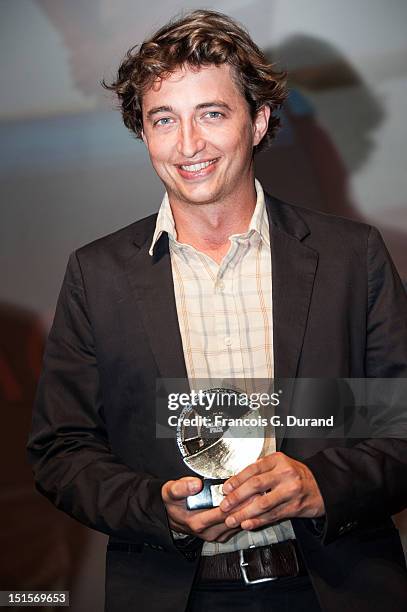 Director Benh Zeitlin poses with its trophies after the closing ceremony of the 38th Deauville American Film Festival on September 8, 2012 in...
