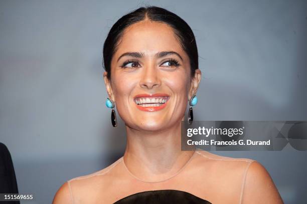 Salma Hayek hands the trophy she received as a tribute for her career during the closing ceremony of the 38th Deauville American Film Festival on...