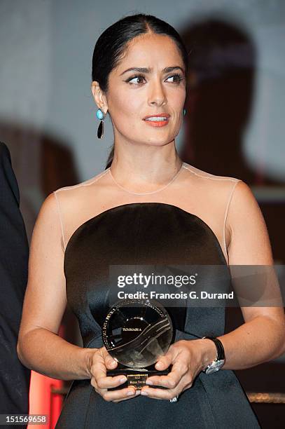 Salma Hayek holds the trophy she received as a tribute for her career during the closing ceremony of the 38th Deauville American Film Festival on...