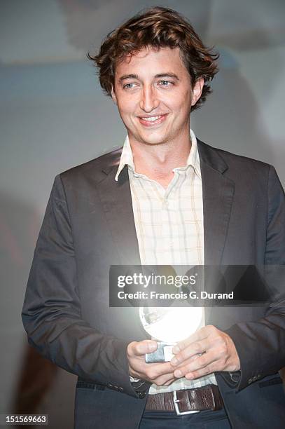 Director Benh Zeitlin poses with its trophies after the closing ceremony of the 38th Deauville American Film Festival on September 8, 2012 in...