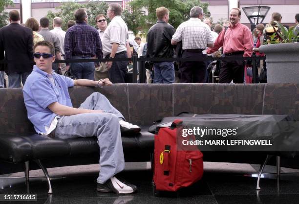Danny Randolph of Cheyenne, Wyoming, makes himself comfortable on a soft couch near the security check-point while his father stands in line 19...