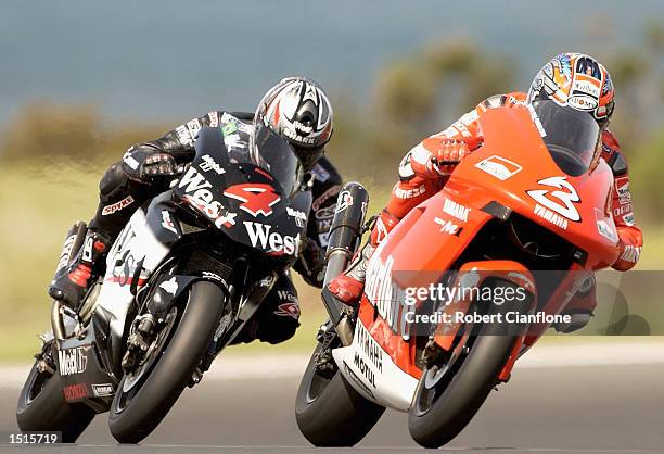 Max Biaggi of Italy and the Marlboro Yamaha Team is closely followed by Loris Capirossi of Italy and the West Honda Pons Team during free practice...