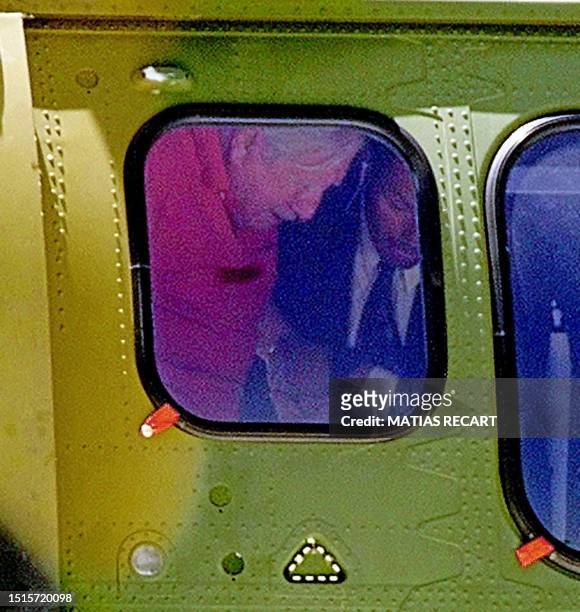 The Chilean ex-dictator Augusto Pinochet is helped by a security agent in a helicopter in Santiago, Chile 27 Janaury 2001. El ex dictador chileno...