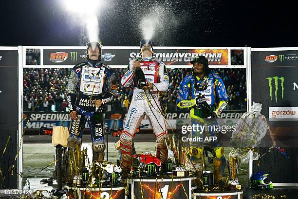 Winner Tomasz Gollob of Poland, second placed Chris Holder of Australia and third placed Antonio Lindback of Sweden spray champagne on September 8,...