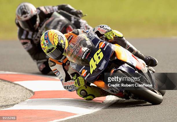 Valentino Rossi of Italy and the Repsol Honda Team leads Alex Barros of Brazil and the West Honda Pons Team during the Skyy Vodka Australian Grand...
