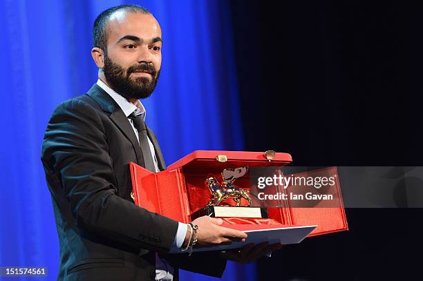 Director Ali Aydin poses with his "Luigi De Laurentiis" award for Debut Film for the film Lion of the Future on stage during the Award Ceremony at...