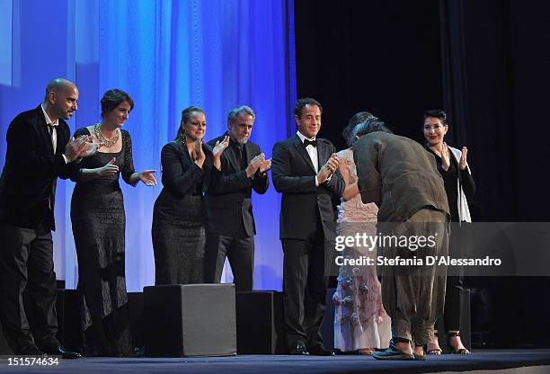 Jury members Pablo Trapero, Ursula Meier, Samantha Morton, Ari Folman, Matteo Garronea and Marina Abramovic applaud whilst winner of the Golden Lion...