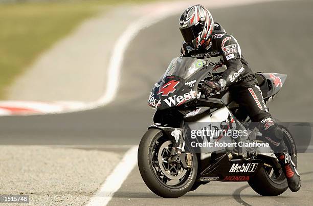 Alex Barros of Brazil and the West Honda Pons Team brakes late on the final lap to hand victory to Valentino Rossi of Italy and the Repsol Honda Team...