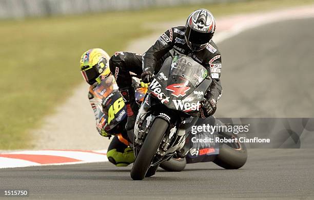 Alex Barros of Brazil and the West Honda Pons Team brakes late on the final lap to hand victory to Valentino Rossi of Italy and the Repsol Honda Team...