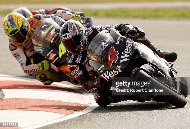Alex Barros of Brazil and the West Honda Pons Team leads Valentino Rossi of Italy and the Repsol Honda Team during the Skyy Vodka Australian Grand...