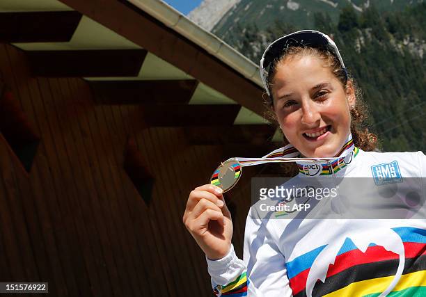 France's olympic and world champion Julie Bresset poses with her medal after winning on September 8, 2012 the women's elite cross country olympic...