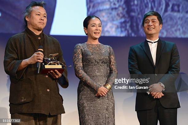 Director Kim Ki-Duk wins the Golden Lion for Best Film award as actress Cho Min-soo looks on during the Award Ceremony at the 69th Venice Film...
