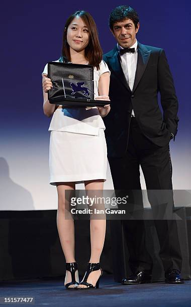 Yoo Min-young receives the Orizzonti Youtube award for Best Short Film for the film Titloi Telous whilst Orizzonti Jury member Pierfrancesco Favino...