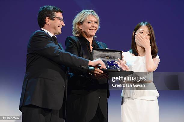 Yoo Min-young receives the Orizzonti Youtube award for Best Short Film for the film Titloi Telous from Jury Members Sandra Den Hamer and Jason Kliot...