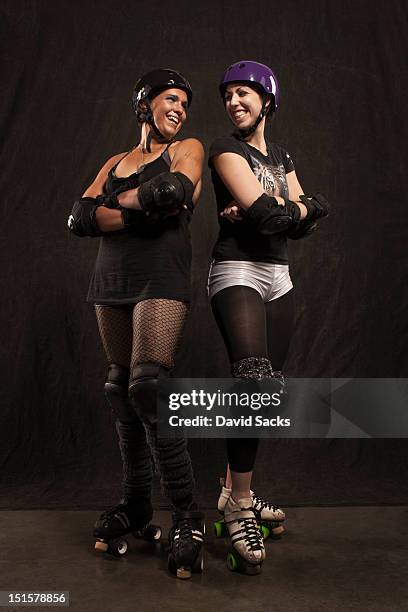portrait of two roller derby girls - roller derby stock pictures, royalty-free photos & images