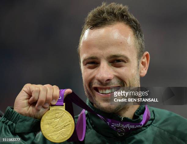 South Africa's Oscar Pistorius poses on the podium with his gold medal after winning the men's 400m - T44 final during the athletics competition at...