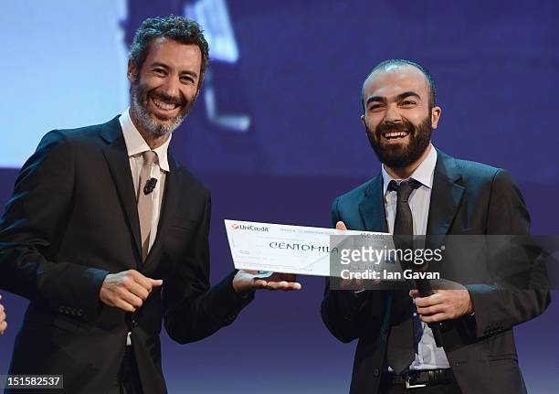 Paolo Kessisoglu and director Ali Aydin with his award for the Lion of the Future 'Luigi De Laurentiis' Venice Award for Debut Film on stage during...