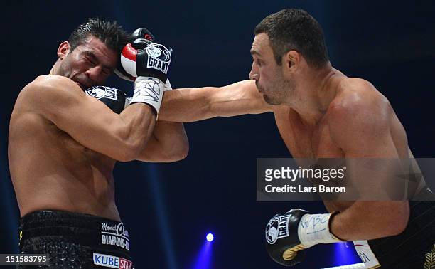 Vitali Klitschko of Ukraine punshes Manuel Charr of Germany during the WBC-heavy weight title fight between Vitali Klitschko of Ukraine and Manuel...