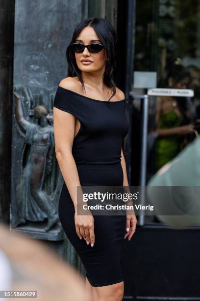 Amina Muaddi is seen wearing black off shoulder dress outside Alexandre Vauthier during the Haute Couture Fall/Winter 2023/2024 as part of Paris...