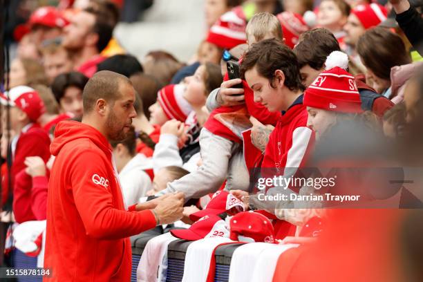 Lance Franklin of the Swans signs autographs after a Sydney Swans AFL training session at Melbourne Cricket Ground on July 05, 2023 in Melbourne,...