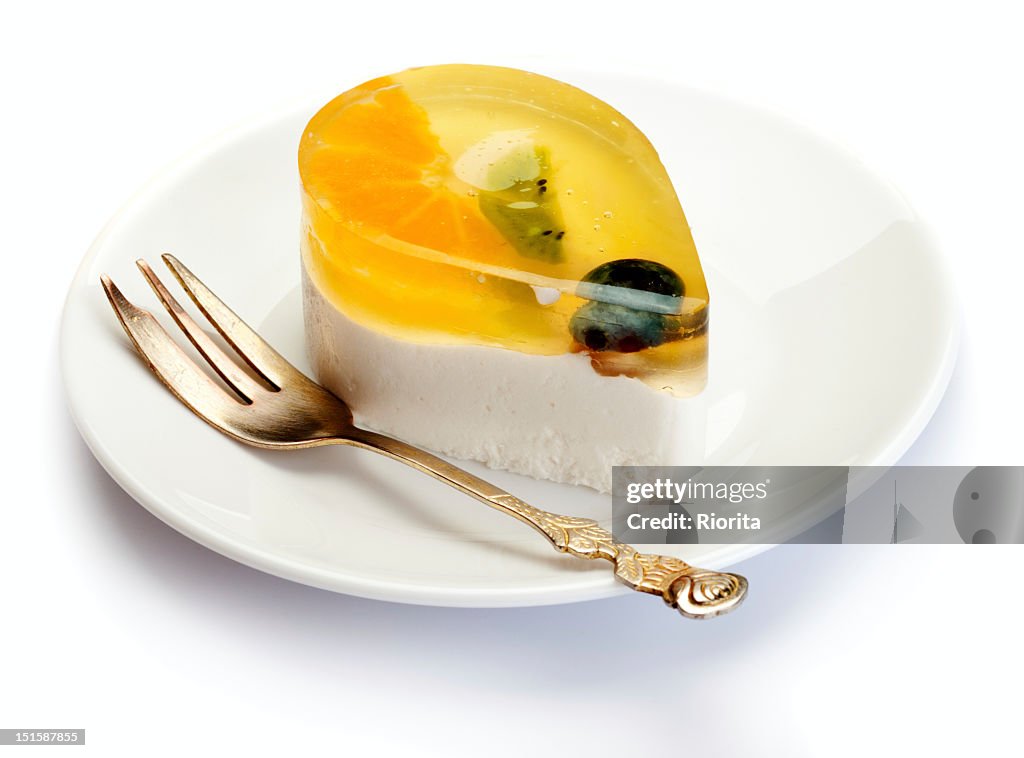 Fruits and jelly cake on white plate