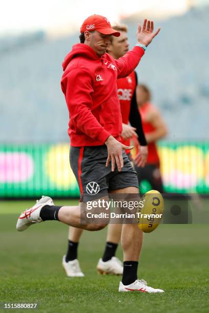 Tom McCartin of the Swans kicks the ball during a Sydney Swans AFL training session at Melbourne Cricket Ground on July 05, 2023 in Melbourne,...