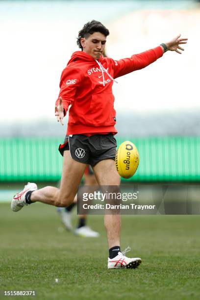 Justin McInerney of the Swans kicks the ball during a Sydney Swans AFL training session at Melbourne Cricket Ground on July 05, 2023 in Melbourne,...