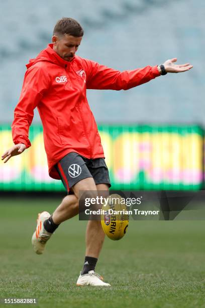 Jake Lloyd of the Swans kicks the ball during a Sydney Swans AFL training session at Melbourne Cricket Ground on July 05, 2023 in Melbourne,...