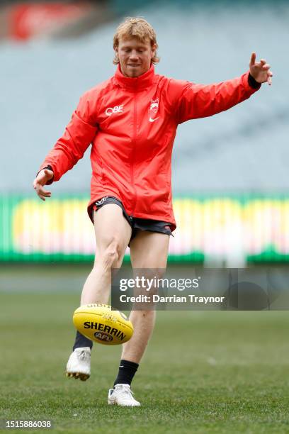 Callum Mills of the Swans kicks the ball during a Sydney Swans AFL training session at Melbourne Cricket Ground on July 05, 2023 in Melbourne,...