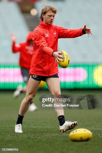 Callum Mills of the Swans kicks the ball during a Sydney Swans AFL training session at Melbourne Cricket Ground on July 05, 2023 in Melbourne,...