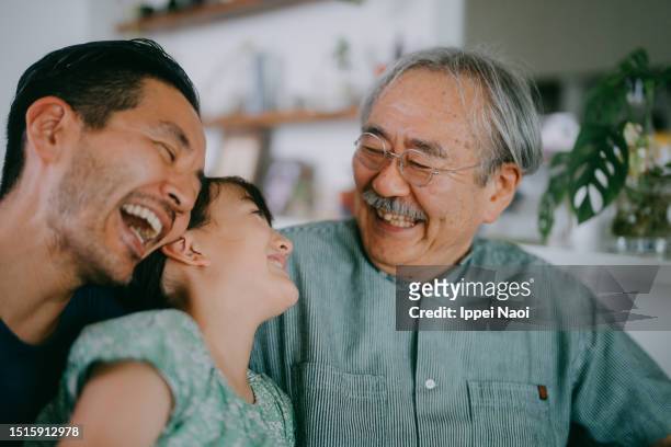 three generation family having a good time on sofa - 家族　元気 ストックフォトと画像