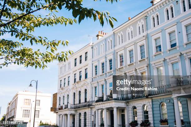pretty pastel row houses in notting hill, london - the 2016 notting hill carnival stock pictures, royalty-free photos & images