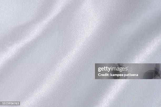 glossy white satin surface: macro shot of shimmering fabric - silk ストックフォトと画像