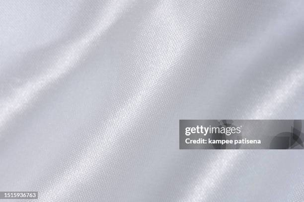 glossy white satin surface: macro shot of shimmering fabric - white silk stock pictures, royalty-free photos & images