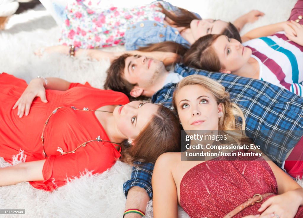 Group of friends lying on rug