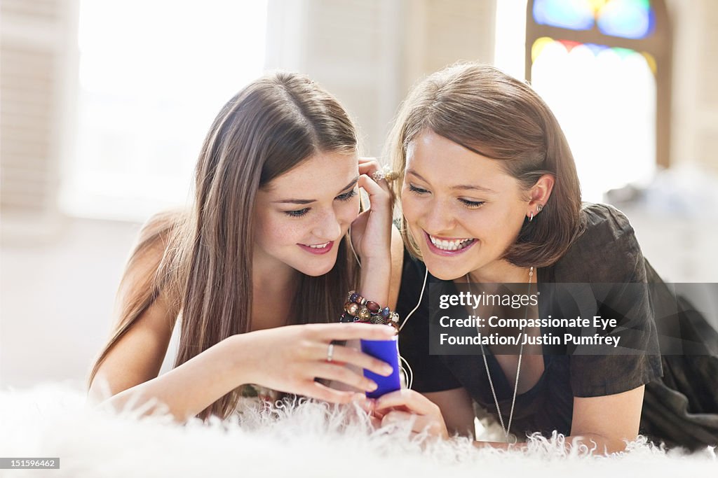 Young women listening to music with mp3 player